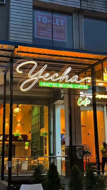 Yecha's neon sign at the café entrance